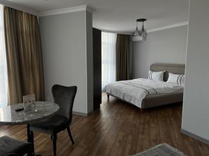 a bedroom with a bed and a table and a chair at 71 East Hotel in Astana +85 photos