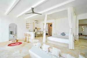 a large white bedroom with a bed and a couch at Sole 1BR Romantic Villa, 5 Min to Thomas Beach in Badung +19 photos