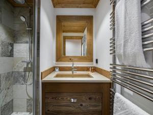 a bathroom with a sink and a mirror at Appartement élégant près des pistes, parking inclus, idéal pour familles – Courchevel Le Praz - FR-1-568-5 in Courchevel +7 photos