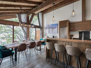 a kitchen and dining room with a table and chairs at Duplex Charmant Près des Pistes avec Hammam et Cheminée à Courchevel Le Praz - FR-1-568-8 in Courchevel