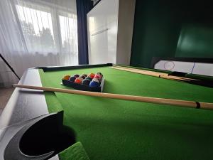 a pool table with balls in a bowl on it at Dom Pod Świerkiem in Ostróda +14 photos