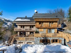 a large wooden house in the snow at Appartement familial calme 8 pers, près des pistes - FR-1-565-51 in Les Allues