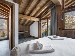 a bedroom with a bed with towels on it at Spacieux appartement de luxe à Courchevel, proche pistes et commerces, parking inclus - FR-1-568-7 in Courchevel