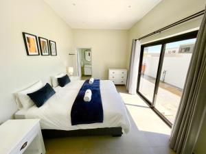 a bedroom with a large bed and a large window at Seaview Luxury loft apartment in Swakopmund