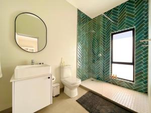 a bathroom with a toilet and a mirror at Seaview Luxury loft apartment in Swakopmund
