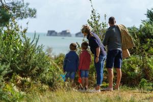 a family standing on a hill looking at the water at Knoll House in Studland