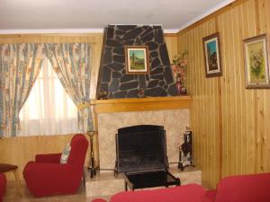 a living room filled with furniture and a fire place at Hostal Carme Pascual in Bohí