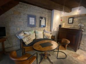 a living room with a couch and a table at A Pers in Saint-Projet