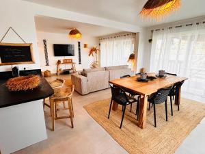 a living room with a wooden table and chairs at Sand and Style, Baie Orientale in Saint Martin