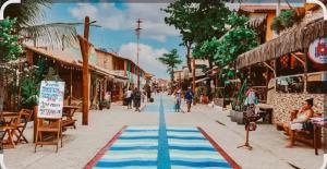 a street with a blue and white rug on the sidewalk at HospedagemCanoa in Aracati