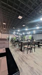 a dining room with tables and chairs in a building at Lider Hotel Tashkent in Muruntau +20 photos