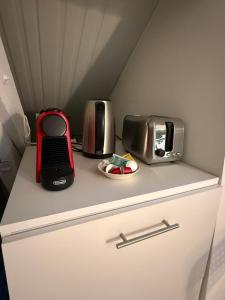 a kitchen counter with a toaster and a toaster oven at Studio Rénové - Cœur de Ville WIFI in Dreux