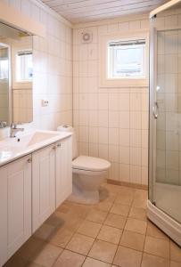 a bathroom with a toilet and a sink and a shower at Stranda Fjellgrend 2 bedrooms - 35c in Stranda