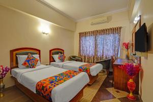 Ένα ή περισσότερα κρεβάτια σε δωμάτιο στο FabHotel Aura Inn - RR Nagar