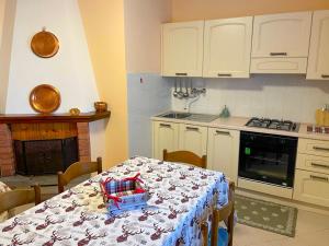 Casa Vacanze - Villa Stefania في بيسكوكوستانزو: مطبخ مع طاولة عليها قطعة قماش +21 صورة