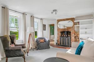 a living room with a fireplace and a couch at Spacious 6-Bed Countryside Home Surrounded by Nature in Sutton Bridge