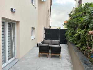 a patio with two chairs and a couch on a balcony at Apartmani Gagi in Vir