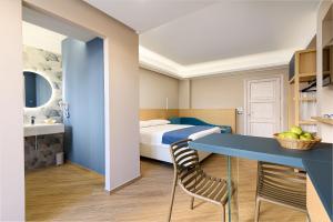 a bedroom with a blue desk and a bed at Hotel Calliope in San Vito lo Capo