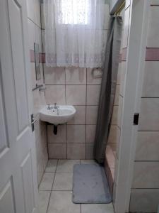 a small bathroom with a sink and a mirror at The Pasture Loft in Mokopane
