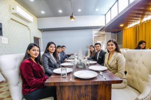 a group of people sitting at a table in a restaurant at FabHotel Golden Temple Paradise - 50 meters from Golden Temple in Amritsar +26 photos