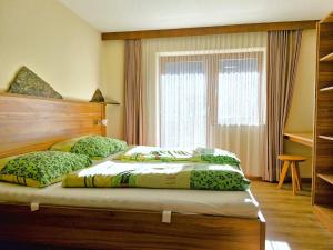 a bedroom with two beds and a window at Holiday Home Waldhof by Interhome in Im Brand