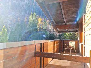 a balcony with a chair and a large window at Holiday Home Waldhof by Interhome in Im Brand
