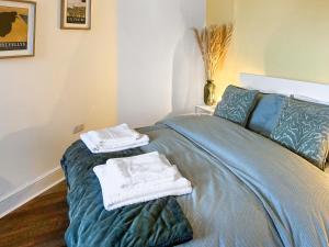 a bedroom with a bed with towels on it at Novena - Uk50586 in Penrith