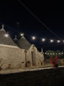 a stone building with lights on it at night at Trulli Pastore in Alberobello