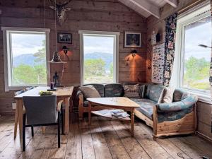 a living room with a couch and a table at Chalet Svanöy by Interhome in Grimeli