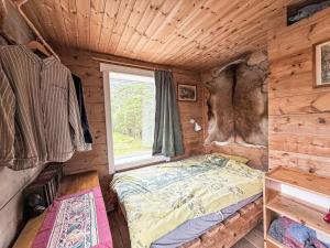 a bedroom with a bed in a log cabin at Chalet Svanöy by Interhome in Grimeli
