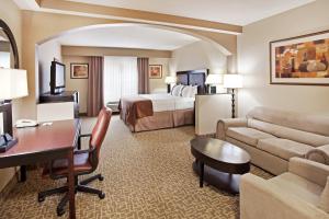 a hotel room with a king bed and a desk at Holiday Inn Hotel & Suites Beaufort at Highway 21 by IHG in Beaufort