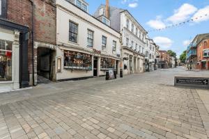 une rue vide dans une vieille ville avec des bâtiments dans l'établissement Boutique central Winchester Abode, à Winchester