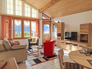 a living room with a couch and a tv at Apartment Am Brienzersee by Interhome in Brienz