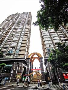 a tall building with an arch in front of it at Baihong Riverview aparment-Chongqing Jiefangbei in Chongqing