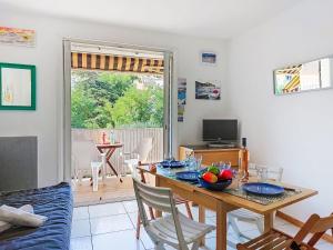 a living room with a table with a bowl of fruit on it at Apartment Les Aigues Marines-36 by Interhome in La Madrague