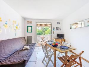 a living room with a couch and a table at Apartment Les Aigues Marines-36 by Interhome in La Madrague
