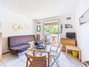a living room with a table and a couch at Apartment Les Aigues Marines-36 by Interhome in La Madrague