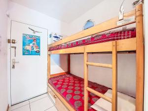 a bunk bed in a room with a red mattress at Apartment Les Aigues Marines-36 by Interhome in La Madrague +8 photos