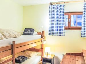 a bedroom with two bunk beds and a window at Chalet Chalet Les 3 Marmottes by Interhome in Moleson +20 photos