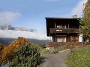 a building with a sign that says hauser on it at Apartment Helene Apt- Hella by Interhome in Wengen