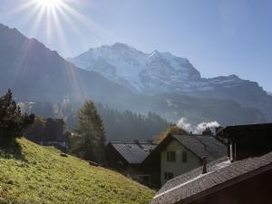 a view of a mountain with the sun in the sky at Apartment Drei Tannen by Interhome in Wengen +29 photos