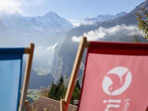 a flag sitting on a chair in front of a mountain at Studio Helene Studio Christel by Interhome in Wengen