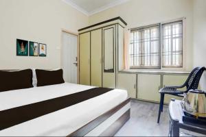 Ένα ή περισσότερα κρεβάτια σε δωμάτιο στο Hotel O Adithya Inn