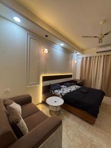 a living room with a bed and a couch at Chalo Chaley Luxury Stays in Ghaziabad +4 photos