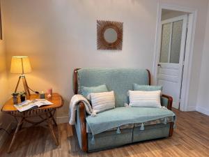 a living room with a chair and a table at Holiday Home Bel Air by Interhome in Cancale +17 photos