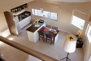 an overhead view of a kitchen and dining area of a house at Plaza Suites Campana in Campana