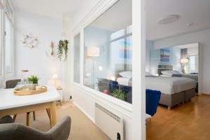 a bedroom with a bed and a desk and a table at Strandbude in Laboe