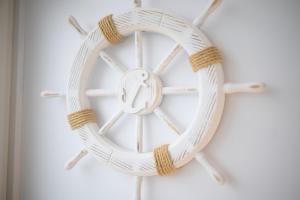 a wooden steering wheel on a wall at Strandbude in Laboe +12 photos