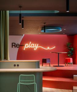 a bar with a red play sign on a wall at Colegio Mayor Resa La Concepción in Valencia