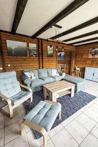 a living room with a couch and a table at Holiday Home Am Hohen Bogen-44 by Interhome in Arrach